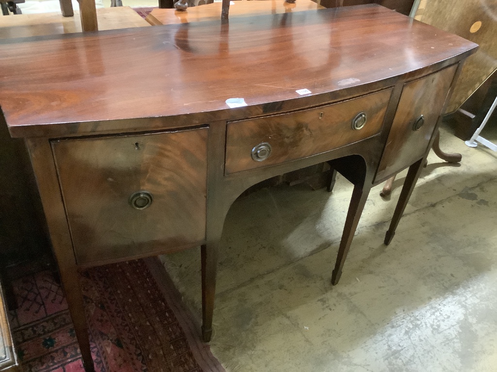 A late 19th century Sheraton style mahogany bowfront sideboard, fitted three drawers, length 140cm, depth 58cm, height 89cm